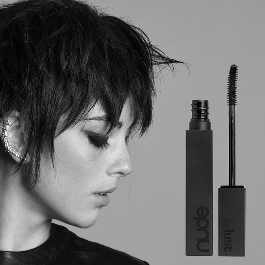 Nude Lust Flirt Mascara in black shade, product packaging with model wearing bold eye makeup